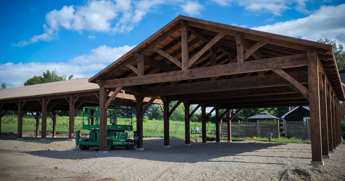 Outdoor timber pavilion under blue sky.